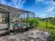 Relaxing screened in pool area featuring three chairs and well manicured lawn at 359 Blue Branch St, Eustis, FL 32736