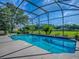 Relaxing screened-in pool area with serene backyard views and plenty of sunlight at 359 Blue Branch St, Eustis, FL 32736