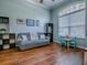 Bright sitting room featuring wood-look floors and a large arched window with blinds at 359 Blue Branch St, Eustis, FL 32736
