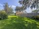 Expansive backyard featuring a well-maintained lawn and a classic wooden fence, under the shade of mature trees at 3664 Se 45Th Pl, Ocala, FL 34480