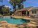 Beautiful home with pool, outdoor kitchen, covered dining area, and lush landscaping at 3664 Se 45Th Pl, Ocala, FL 34480