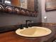 Close-up of bathroom sink with decorative mirror, granite countertop, and bronze fixtures at 3664 Se 45Th Pl, Ocala, FL 34480