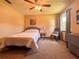 Cozy bedroom featuring soft carpet, neutral walls, and a ceiling fan at 3664 Se 45Th Pl, Ocala, FL 34480