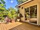 Wooden deck with sliding door, tropical landscaping, and bright sunlight at 3664 Se 45Th Pl, Ocala, FL 34480