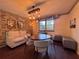 This dining area features a unique lighting fixture, brick wall, and decorative shelving at 3664 Se 45Th Pl, Ocala, FL 34480