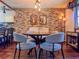 Dining area showcases a rustic brick wall, modern lighting, and cozy seating at 3664 Se 45Th Pl, Ocala, FL 34480