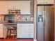 Kitchen area featuring a stainless steel refrigerator and a built-in desk area with a stool at 3664 Se 45Th Pl, Ocala, FL 34480