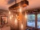 This dining area features a unique lighting fixture, brick wall, and decorative shelving at 3664 Se 45Th Pl, Ocala, FL 34480