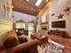 Living room with a stone fireplace, wood ceiling, skylights, and comfortable seating, creating a warm and inviting space at 3664 Se 45Th Pl, Ocala, FL 34480