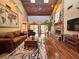 Spacious living room featuring a stone fireplace, vaulted ceilings, and hardwood floors at 3664 Se 45Th Pl, Ocala, FL 34480