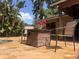 Outdoor pool area with stone flooring, stone fire pit table, and tropical landscaping at 3664 Se 45Th Pl, Ocala, FL 34480
