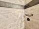 Modern tiled shower with bronze fixtures, recessed shelf, and grey accent tile at 3664 Se 45Th Pl, Ocala, FL 34480