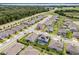 A high-angle shot of a neighborhood featuring well-placed homes, trees, and road networks with a house outlined at 391 Cheeota Ct, Minneola, FL 34715