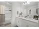 Well-lit bathroom featuring double sinks, spacious vanity, and shower tub combination at 391 Cheeota Ct, Minneola, FL 34715