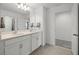 Bathroom featuring a double vanity, granite counters, and spacious mirrors at 391 Cheeota Ct, Minneola, FL 34715