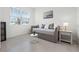 Bedroom with neutral tones featuring a daybed, modern decor, and natural light at 391 Cheeota Ct, Minneola, FL 34715