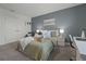 Bedroom with gray accent wall featuring a comfortable bed and a desk at 391 Cheeota Ct, Minneola, FL 34715