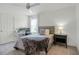 Bedroom featuring a comfortable bed, desk, and ceiling fan at 391 Cheeota Ct, Minneola, FL 34715
