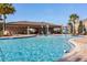 Community pool with splash pad, lounge chairs, and covered seating area for residents to relax and enjoy at 391 Cheeota Ct, Minneola, FL 34715
