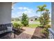 Inviting front porch featuring brick pathway, lush landscaping and charming bench at 391 Cheeota Ct, Minneola, FL 34715