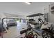 Open garage space with golf cart, car, gym equipment, and storage at 391 Cheeota Ct, Minneola, FL 34715