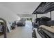 View of garage featuring golf cart and car with the garage door open and natural light at 391 Cheeota Ct, Minneola, FL 34715