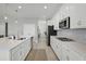 Bright kitchen featuring stainless appliances, white cabinets, and a kitchen island at 391 Cheeota Ct, Minneola, FL 34715
