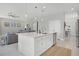 Modern kitchen with an island, stainless steel appliances, and bright lighting at 391 Cheeota Ct, Minneola, FL 34715