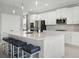 Well-appointed kitchen featuring a spacious island, white cabinets, and modern fixtures at 391 Cheeota Ct, Minneola, FL 34715