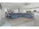Spacious living room with a large sectional, stylish decor, and ample natural light at 391 Cheeota Ct, Minneola, FL 34715