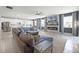 Open-concept living space with modern fireplace, large sectional sofa, and gourmet kitchen at 391 Cheeota Ct, Minneola, FL 34715