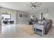 Bright living room with comfortable seating, view to the patio, and neutral decor at 391 Cheeota Ct, Minneola, FL 34715
