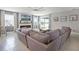 Cozy living room with fireplace, large sectional sofa, and natural light at 391 Cheeota Ct, Minneola, FL 34715