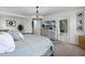 Well-lit main bedroom features a bed, dresser, access to the bathroom, and decor at 391 Cheeota Ct, Minneola, FL 34715