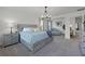 Spacious main bedroom features a bed, nightstands, decor, and a lounge area at 391 Cheeota Ct, Minneola, FL 34715