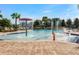 Community pool featuring splash pad with water features and comfortable lounge chairs on the pool deck at 391 Cheeota Ct, Minneola, FL 34715