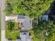 Expansive aerial view of a home surrounded by lush trees, greenery, and waterfront access at 4219 Magnolia Ave, Leesburg, FL 34748