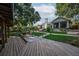 Backyard with fire pit, seating, lush landscaping and manicured lawn at 4219 Magnolia Ave, Leesburg, FL 34748