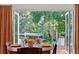 Dining area with french doors leading to scenic outdoor view with lush greenery at 4219 Magnolia Ave, Leesburg, FL 34748