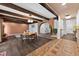 Dining room featuring exposed wood beams, hardwood floors, and a brick archway at 4219 Magnolia Ave, Leesburg, FL 34748