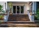 Front entrance with brick steps, lighting, and fresh landscaping at 4219 Magnolia Ave, Leesburg, FL 34748