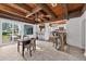 Bright game room featuring exposed wood beams, bar seating and a chess table at 4219 Magnolia Ave, Leesburg, FL 34748