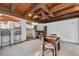 Bright game room featuring exposed wood beams, bar seating and a chess table at 4219 Magnolia Ave, Leesburg, FL 34748