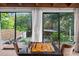 Game room featuring a chess table and expansive windows overlooking the lush backyard at 4219 Magnolia Ave, Leesburg, FL 34748