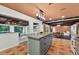 Spacious kitchen with an island, tiled floor and views of the dining room at 4219 Magnolia Ave, Leesburg, FL 34748