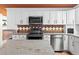 Modern kitchen featuring granite countertops, stainless steel appliances, and sleek white cabinets at 4219 Magnolia Ave, Leesburg, FL 34748