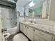 Bathroom featuring marble countertop and white vanity with a shower and tub combo at 424 Hawthorne Blvd, Leesburg, FL 34748