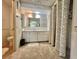 Neutral bathroom featuring a full vanity, large mirror and tiled walls at 424 Hawthorne Blvd, Leesburg, FL 34748