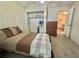 Comfortable bedroom showcasing a closet, a dresser, and easy access to the bathroom at 424 Hawthorne Blvd, Leesburg, FL 34748