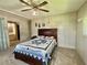 Bedroom featuring a cozy bed with a blue and white quilt and a vintage ceiling fan at 424 Hawthorne Blvd, Leesburg, FL 34748